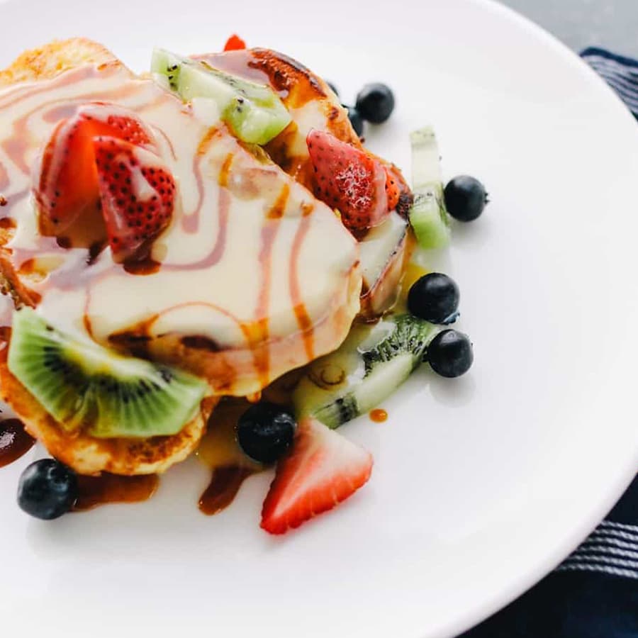 French toast with fresh fruit and creamy icing on top